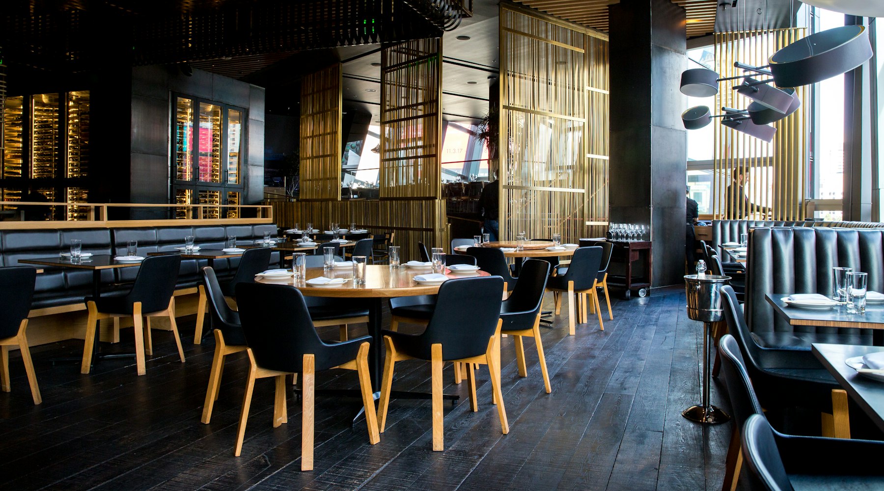 Comedor de BRASA en penumbra con las mesas iluminadas puntualmente